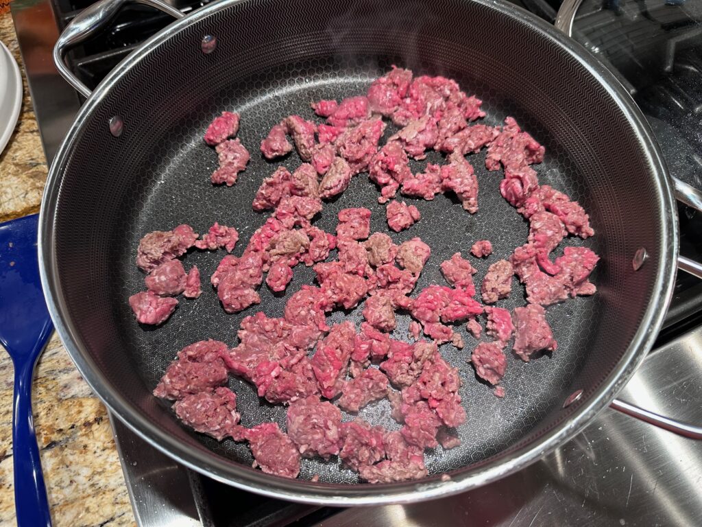 ground beef in a large skillet beginning to cook