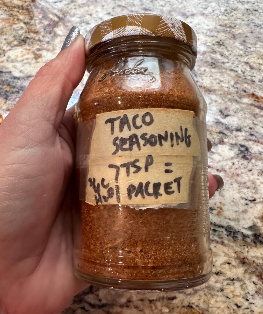 homemade taco seasoning kept in an old jelly jar.  7 Tsp seasoning + 3/4 C of water added to 1 lb meat makes quick tacos