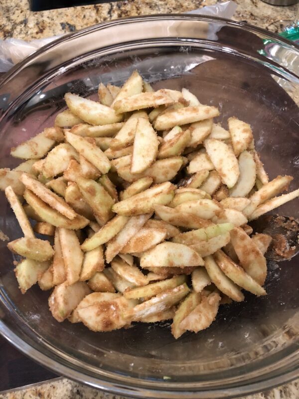 Apples, brown sugar, white sugar, cinnamon, nutment, a smidge of lemon juice and flour in a large bowl