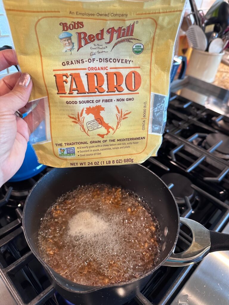 Farro package shown with Farro simmering in a pot on the stove 