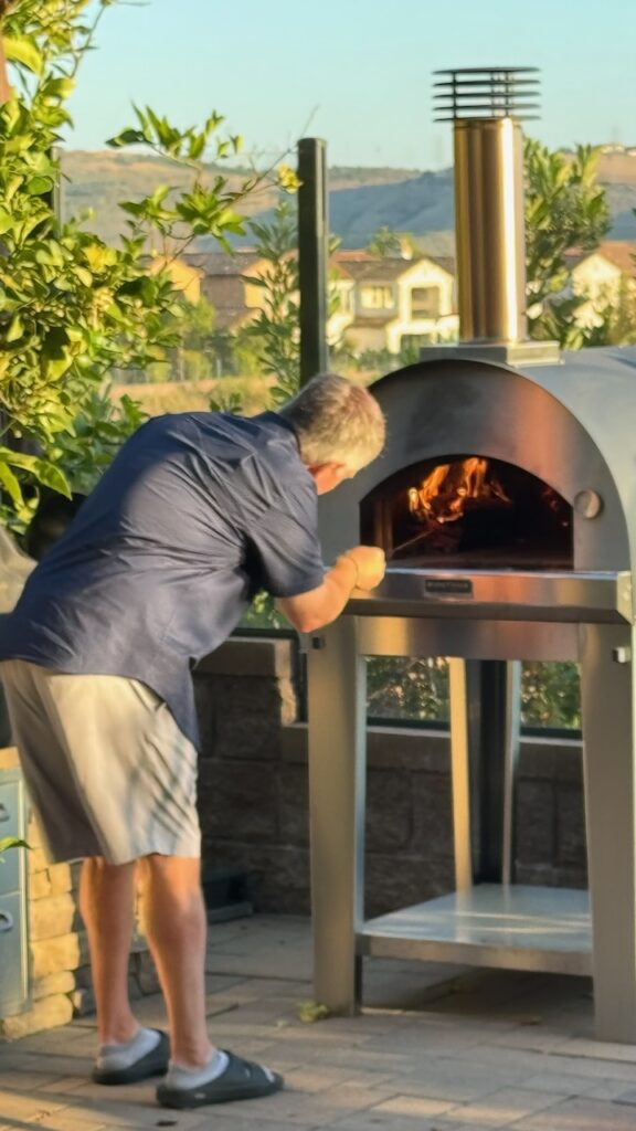 Dave at the grill / with his GIANT spatula used for getting pizza off the grill 