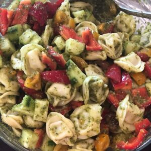 Cheese Tortellini salad with tomatoes, peppers, cucumbers, corn and basil vinaigrette