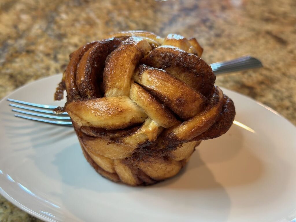 cinnamon expresso roll on a plate with a fork