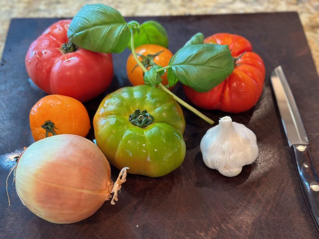 ingredients needed for roasted heirloom tomato soup : basil, oregano, onion and garlic are key 