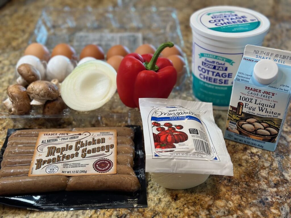 Ingredients used shown :  12 eggs, 1 pint egg whites, 3 C cottage cheese, some onion, mushrooms, red pepper, low fat mozzarella and maple chicken breakfast sausages