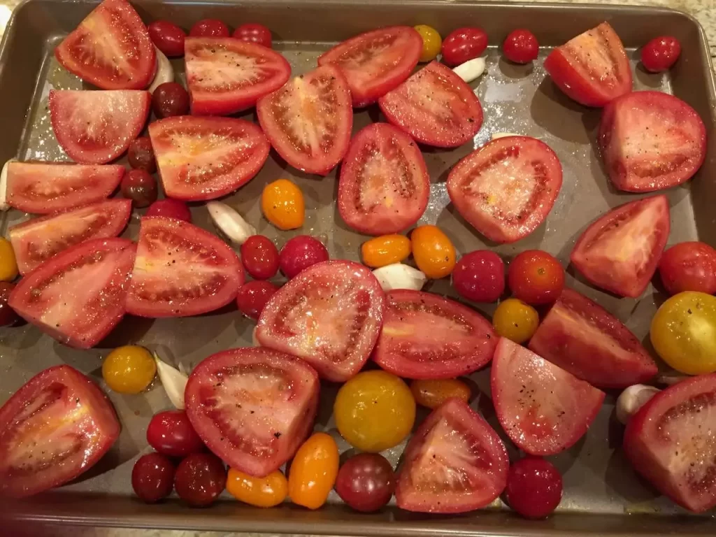 Roasting up plum tomatoes and grape tomatoes with some garlic - still in the peel