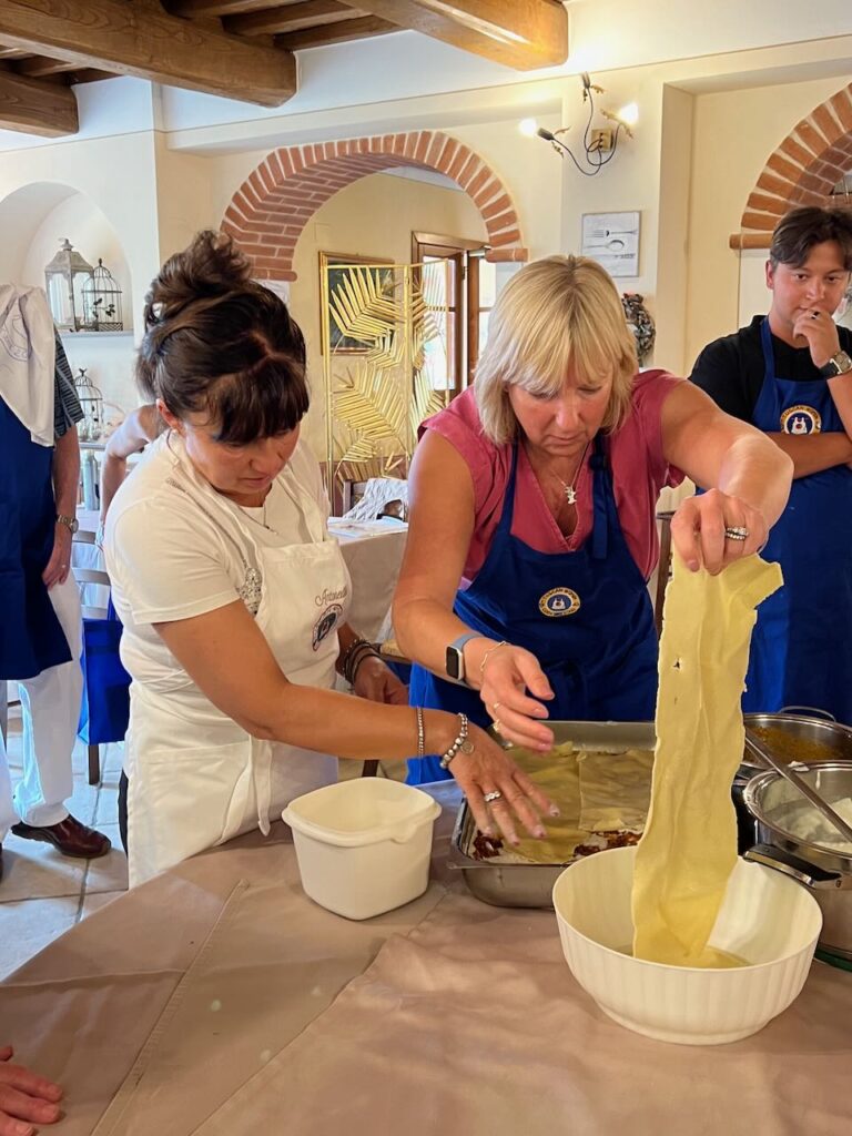 Me - pulling fresh and slightly cooked pasta out of a bowl to build a layer of lasagna  