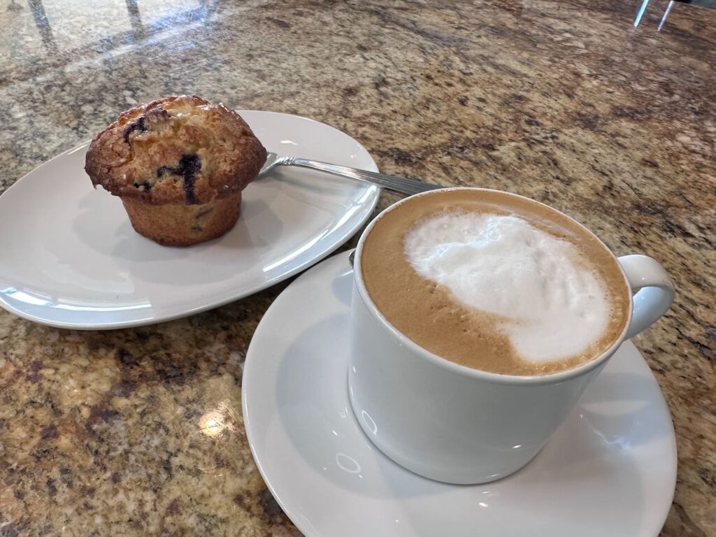 Easy Lemon Blueberry muffin ready to eat with a nice cappuccino