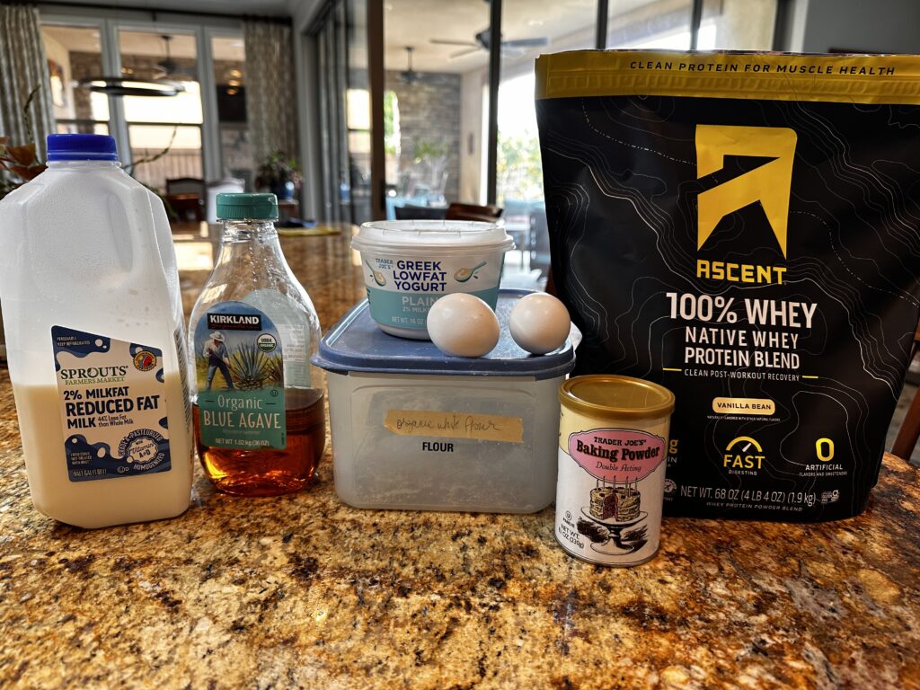 Ingredients shown for the high protein breakfast bake - Milk, Agave (sweetener), flour, greek yogurt, baking powder and Whey Protein powder