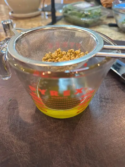 Herbs and Garlic separated from the olive oil that will be used on the potatoes to roast