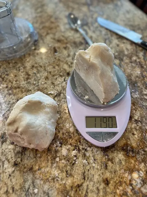 weighing out the pie crust for wrapping and placing in the fridge