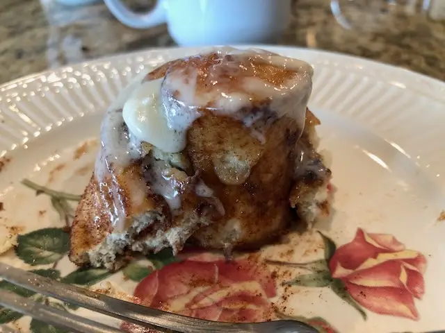 A fresh yummy cinnamon roll down to the goooey oooyie center.