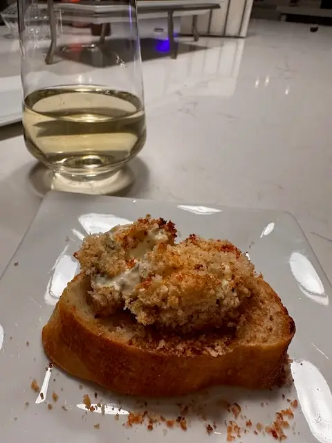 glass of wine - fresh baguette - and hot crab dip looking yummy 