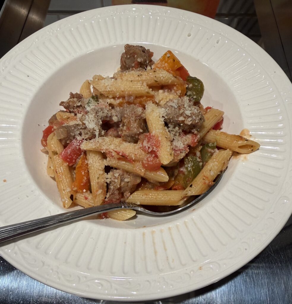 Bowl of italian sausage, peppers, onions and pasta - with a nice bit of parmesan on top. 